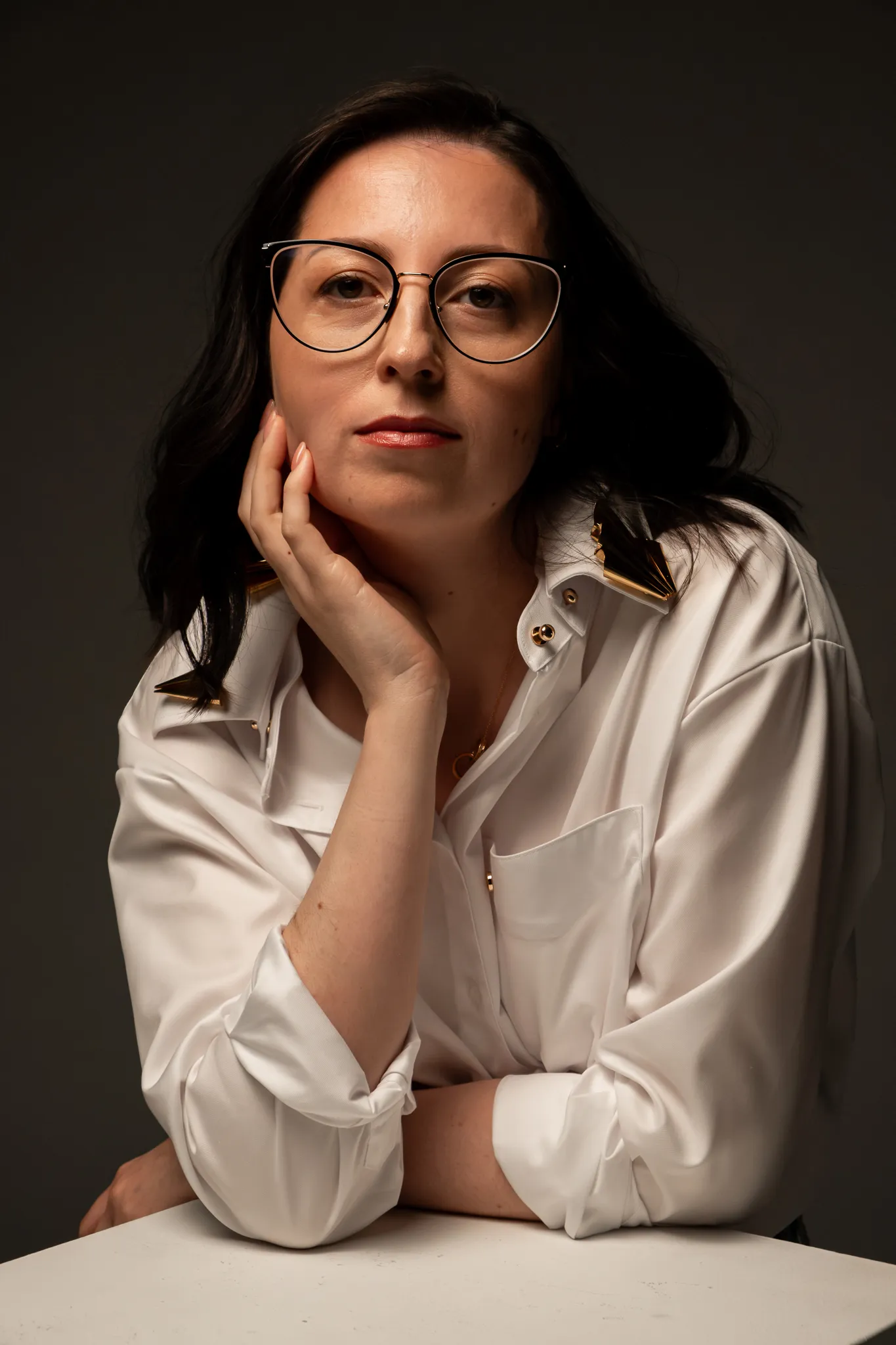 Studio portrait of Looking Friday founder and designer Libby Tolm wearing a structured white button-down shirt.