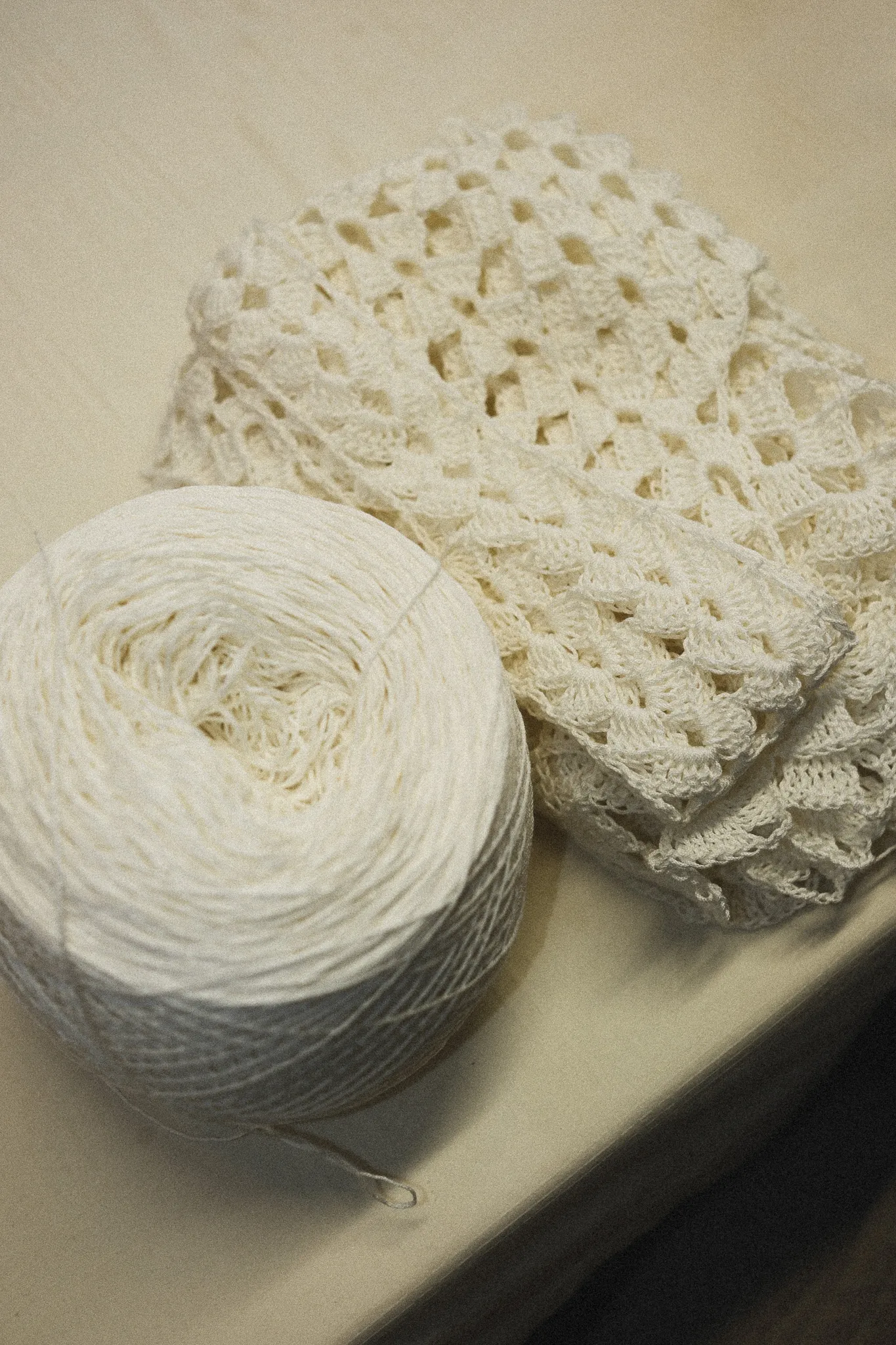A detailed view of natural fiber yarn and hand-sculpted crochet work, representing our commitment to zero-waste, archive-first sourcing and synthetic-free craftsmanship.