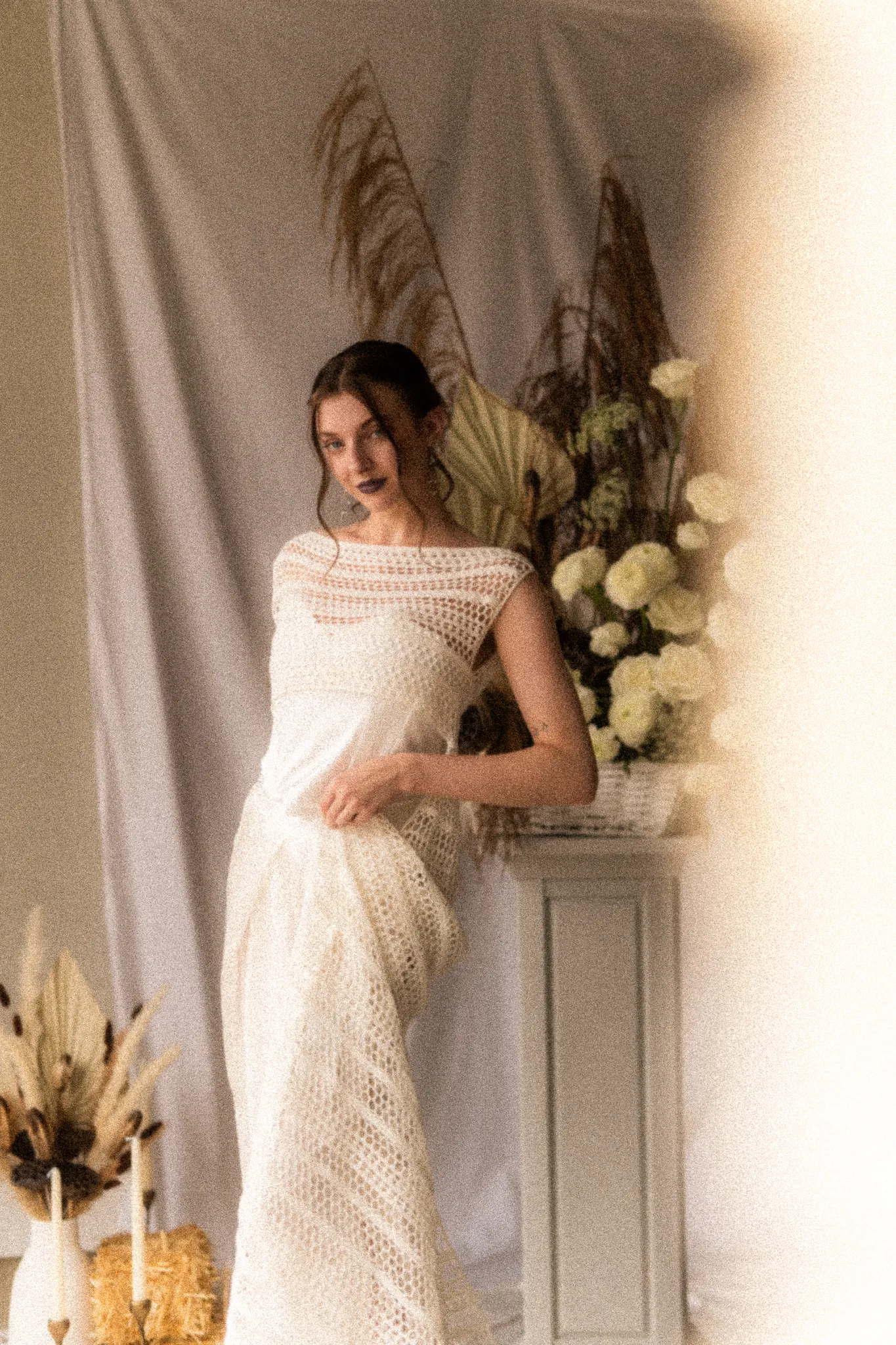 Front view of Looking Friday's Marlene Suit showing a structured white silk corset paired with open-work hand-crocheted sheer overlay and draped silk trousers.